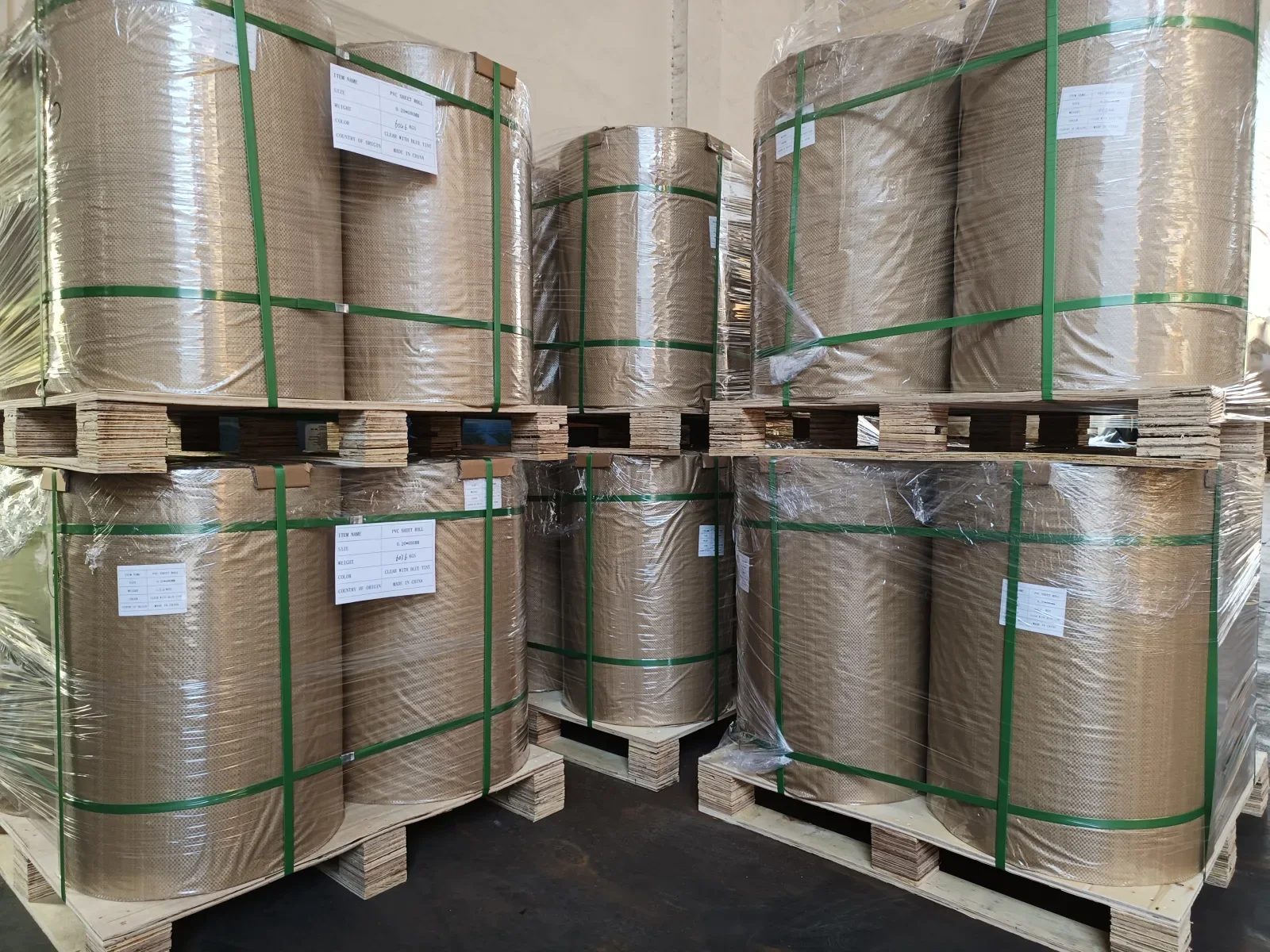 Packed PVC rigid film rolls from a completed export shipment, protected for transport before downstream die cutting