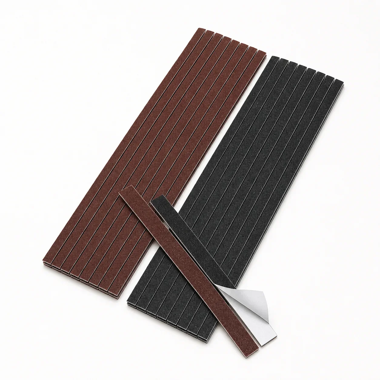 Brown and black adhesive-backed sandpaper grip strips for garment templates