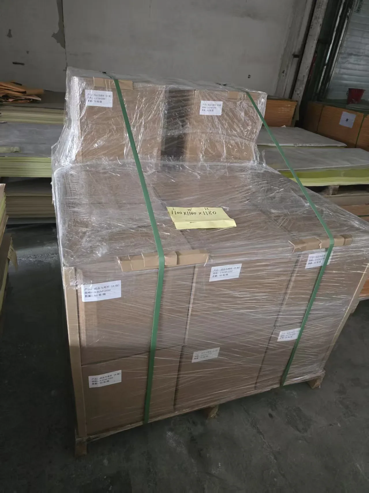 Wrapped garment template materials labeled and strapped on a pallet before export